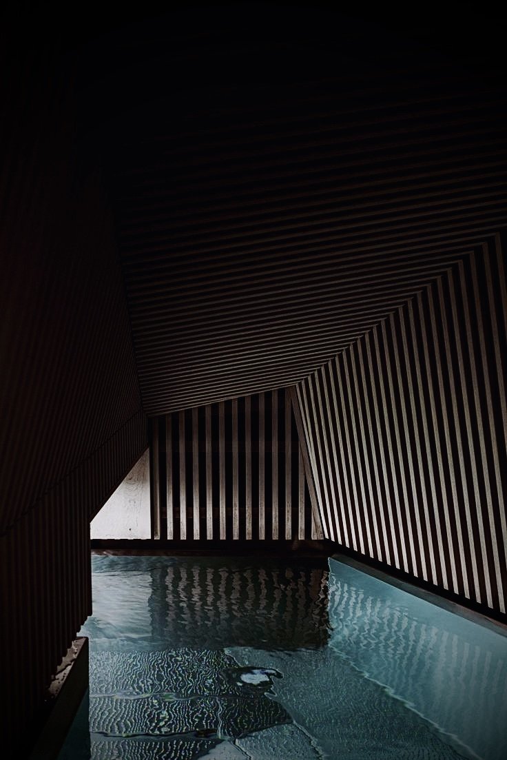 Hamaria Club luxury pool with architectural slatted ceiling featuring modern aquatic training facilities and sophisticated wellness design in Madrid